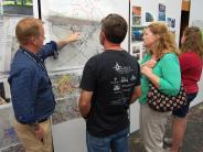 People discussing while looking at project map