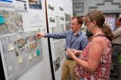 A Stantec staffer discusses ideas with a visitor.
